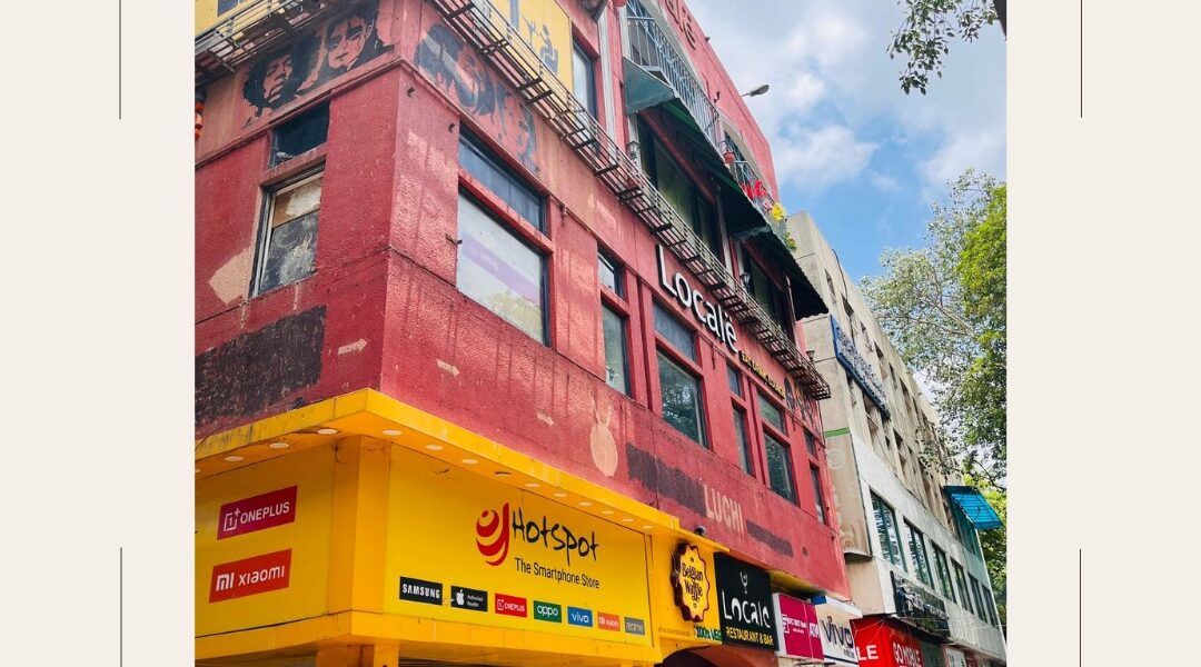 Real image of commercial building for sale in Saket near PVR Complex, featuring retail outlets and restaurants in a high-footfall commercial zone.